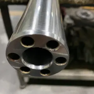 Precision Machined Ram End Face — Astro Tool & Machine Co. Close-up of a precision machined ram end face showing a center bore and threaded mounting holes at Astro Tool & Machine Co.