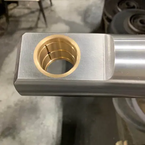 Bronze Bearing Press-Fit in Ram — Astro Tool & Machine Co. Close-up of a bronze bearing press-fit into a bodymaker ram end at Astro Tool & Machine Co.