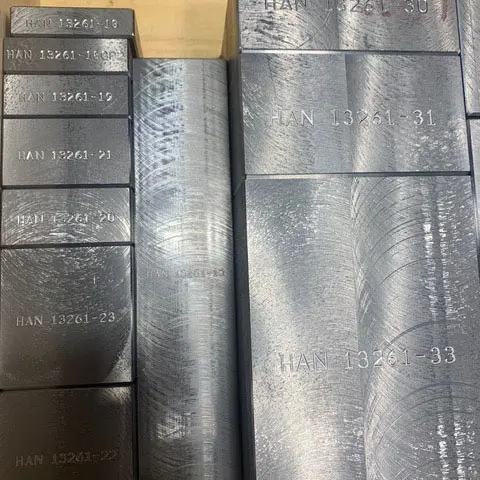 Stacked, part-numbered metal stock organized for inventory at Astro Tool & Machine Co.